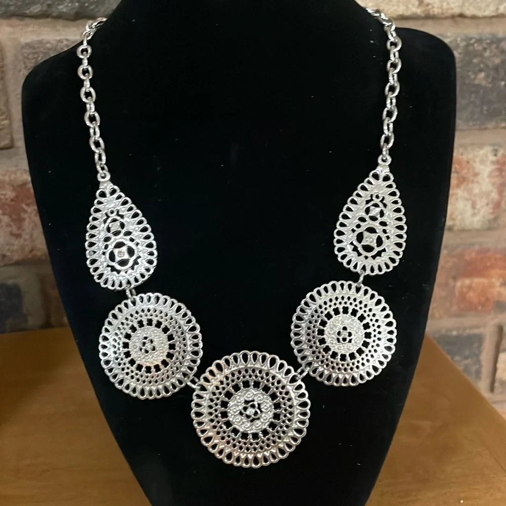 Silver tone medallion with rhinestone accent statement necklace